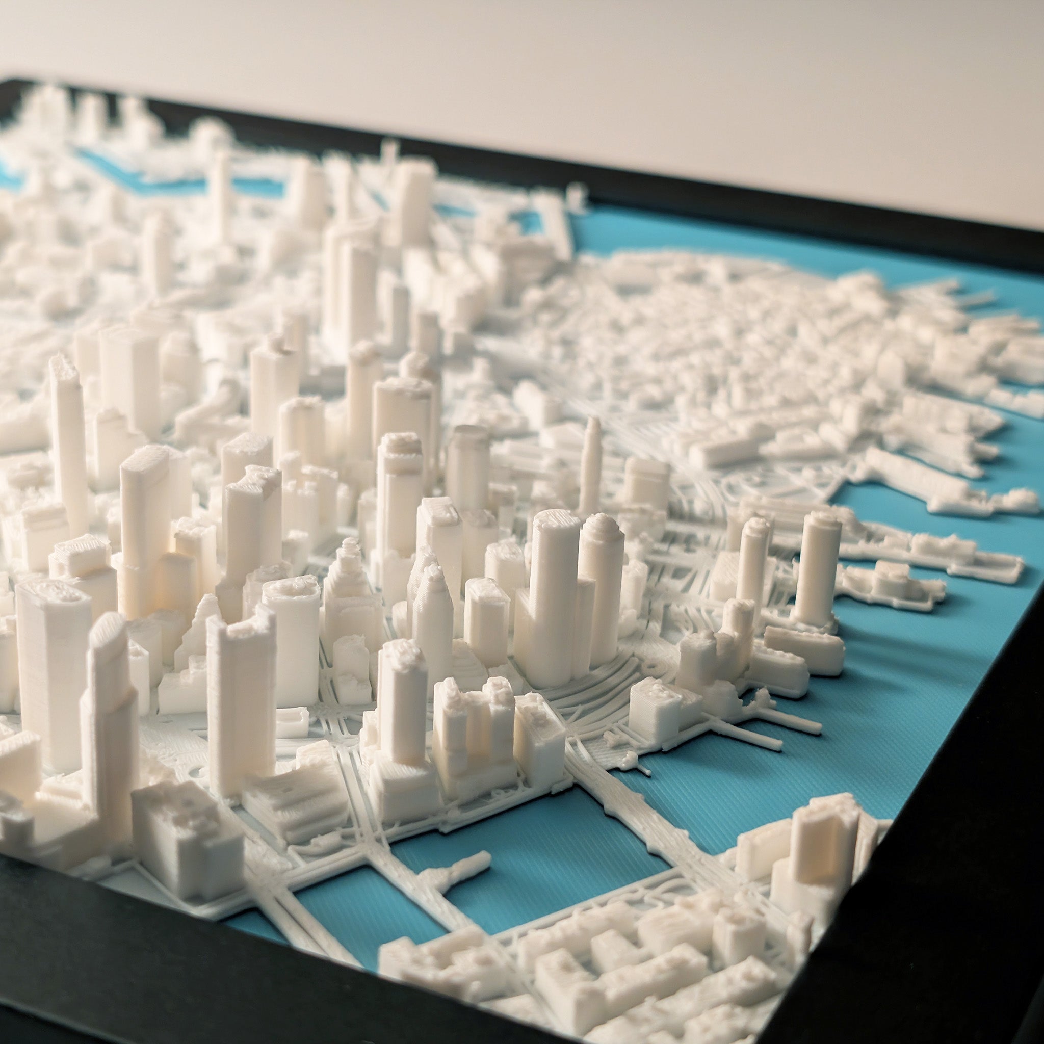 3D model of a cityscape with white buildings on a blue base