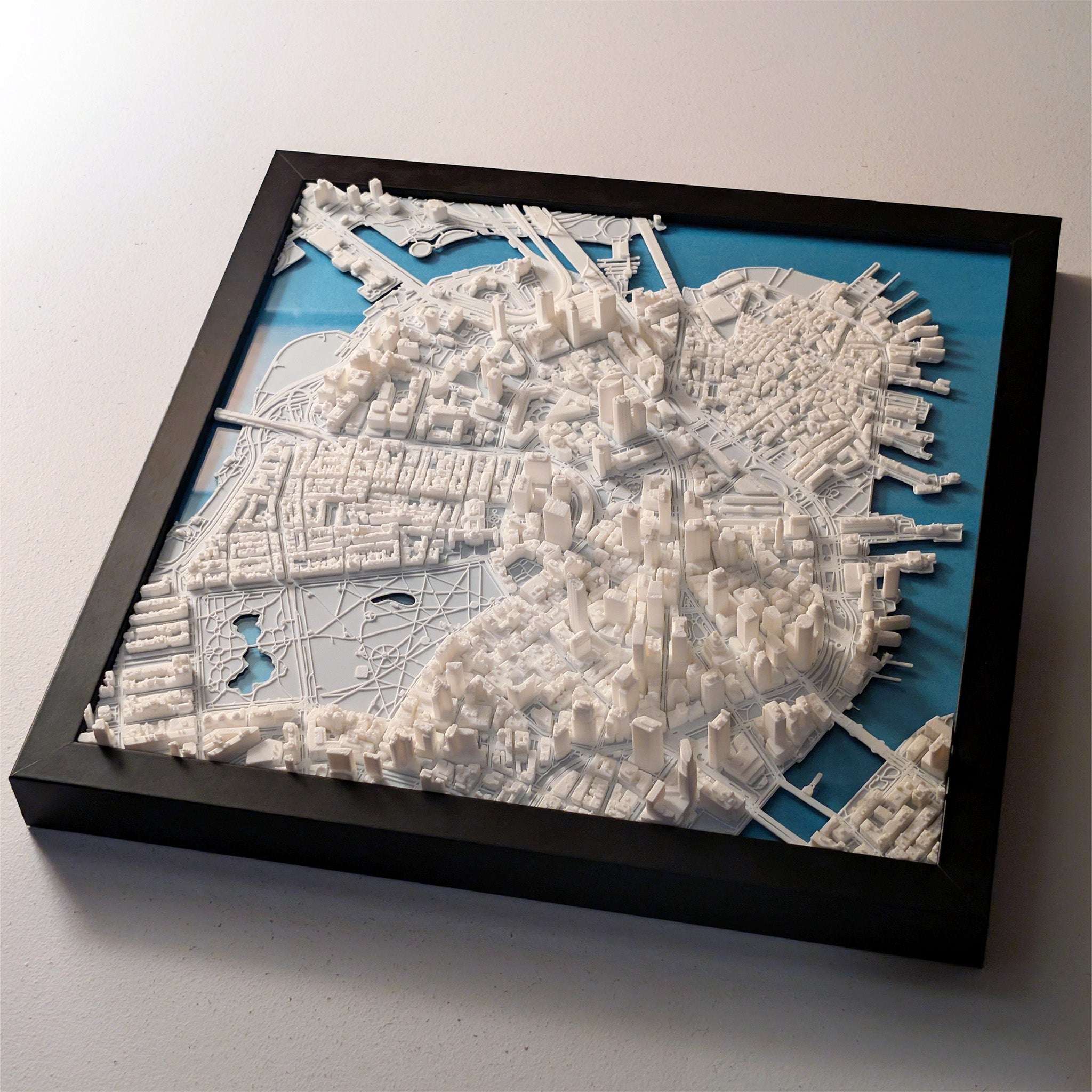 Framed 3D cityscape model on a white background