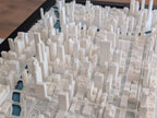 The Chicago 3D Map is a detailed white model featuring high-rise buildings and streets, viewed from above—ideal wall art for fans of the iconic Chicago skyline.