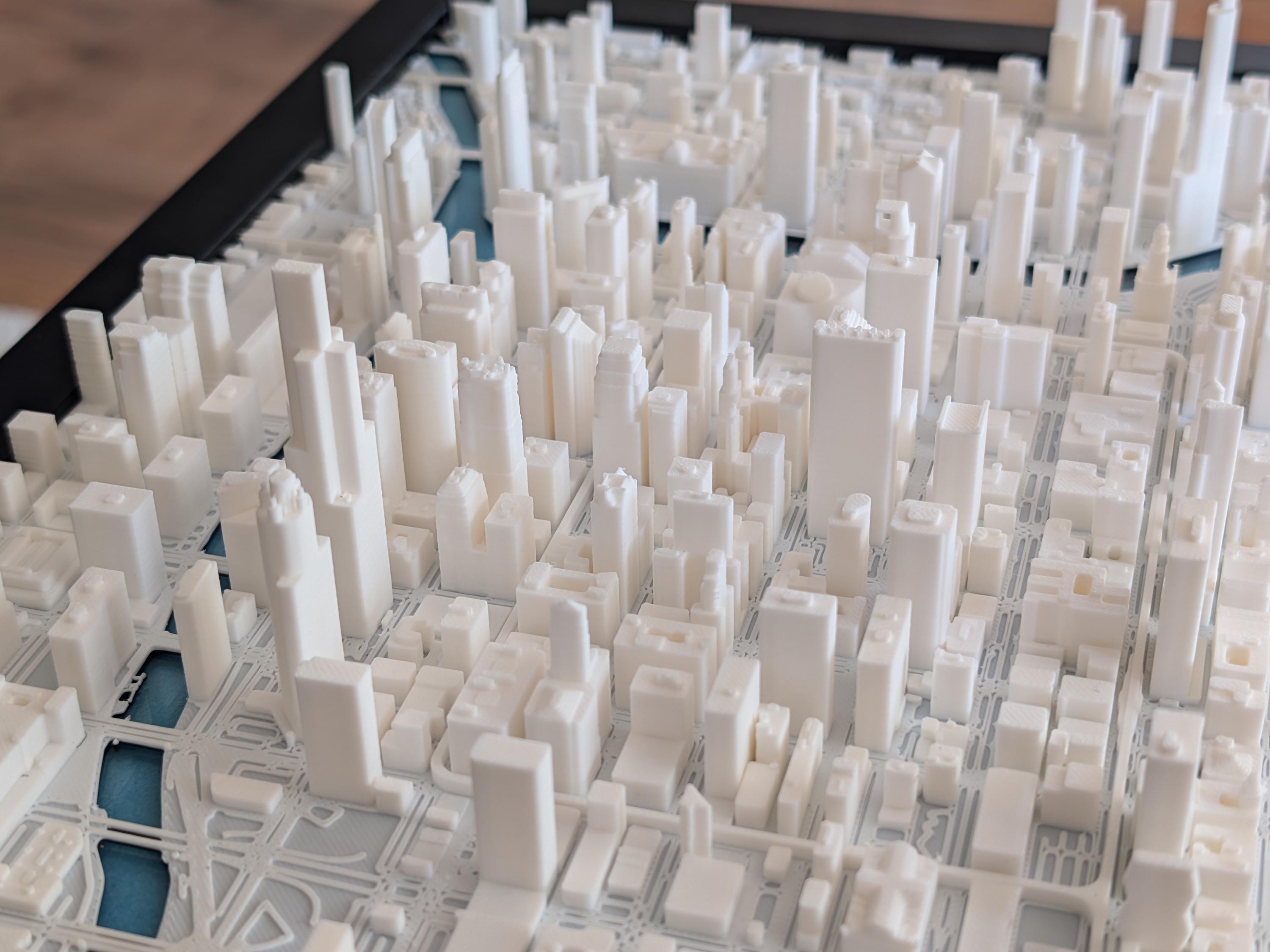 The Chicago 3D Map is a detailed white model featuring high-rise buildings and streets, viewed from above—ideal wall art for fans of the iconic Chicago skyline.